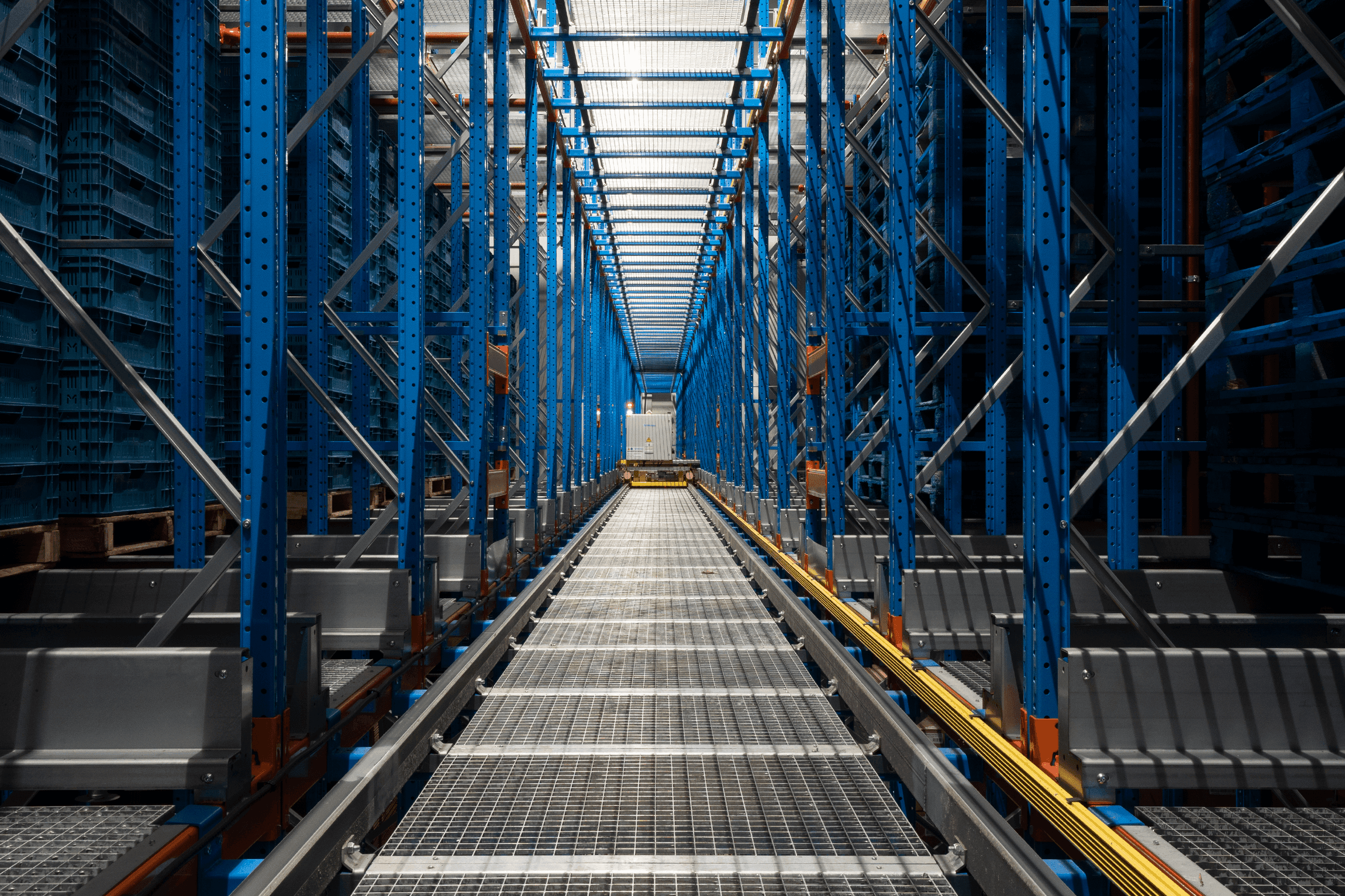 Viscon Matrix storage system aisle with blue racking and shuttle rails